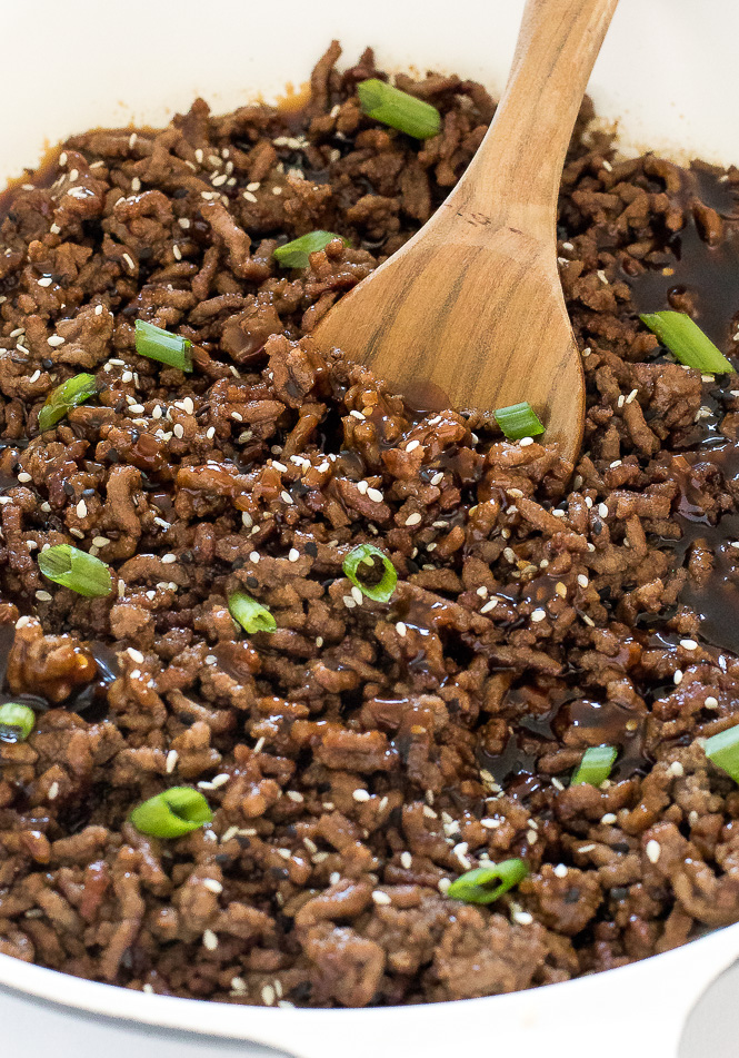 Korean Beef Rice Bowls | chefsavvy.com Korean Beef Bowl Recipe with a wooden spoon.