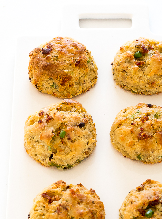 Easy Bacon Cheddar Biscuits | chefsavvy.com Bacon Cheddar Biscuits on a white chopping board.