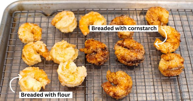 Comparison photo of shrimp breaded in flour versus breaded in cornstarch. 