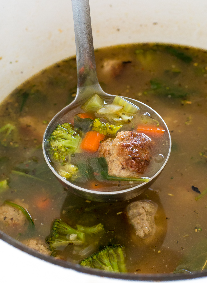 a ladle scooping out a serving of this a serving of this Turkey Meatball Vegetable Soup from a dutch oven 