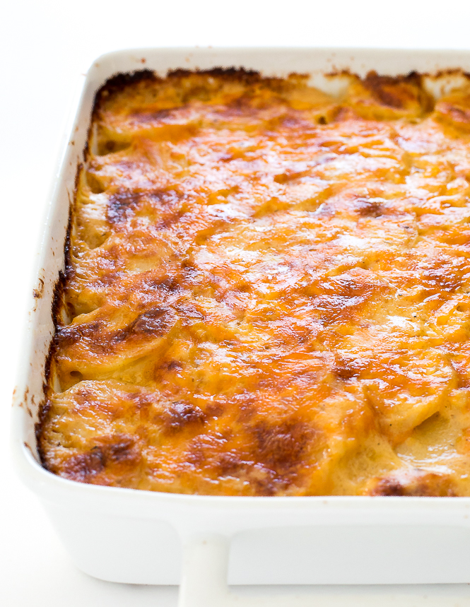 Cheesy Scalloped Potatoes Recipe in white baking dish