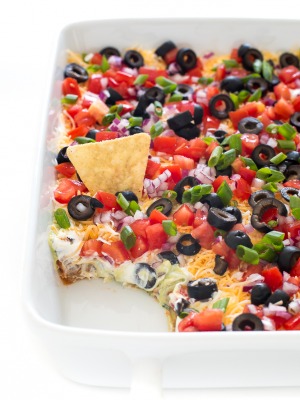 top shot of easy 7-layer dip in white baking dish