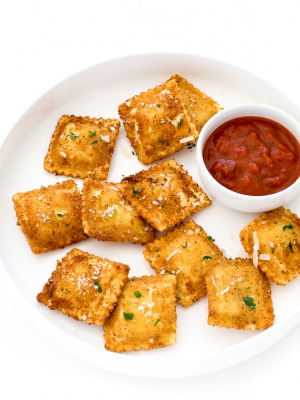 Toasted Ravioli on a white plate with marinara sauce