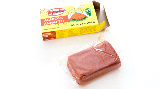 A box of achiote paste opened on a white table