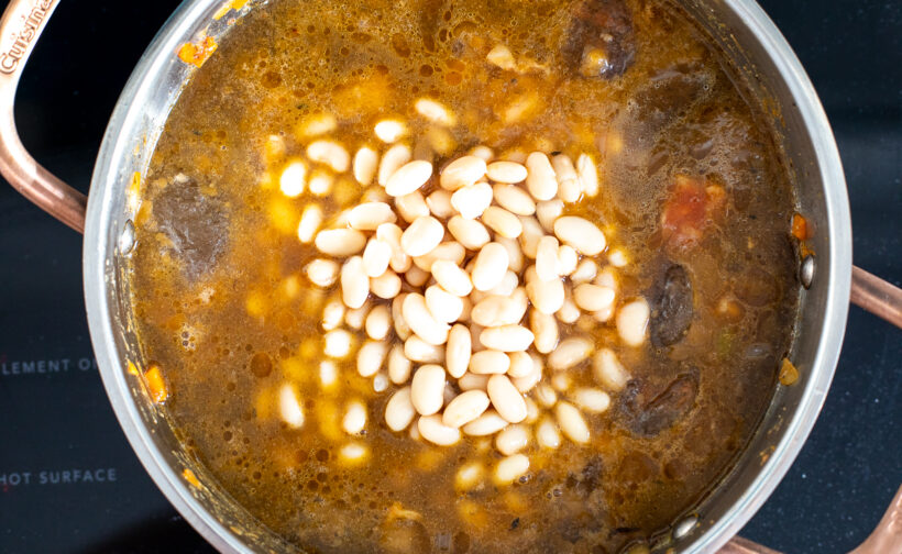 Buffalo chicken chili simmering in pot on stove.