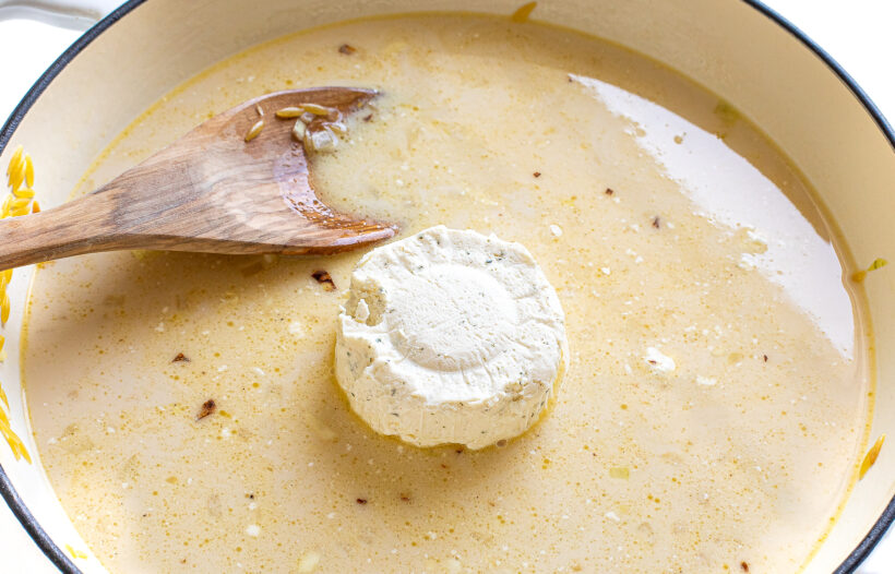 Sauce ingredients added to orzo to skillet.