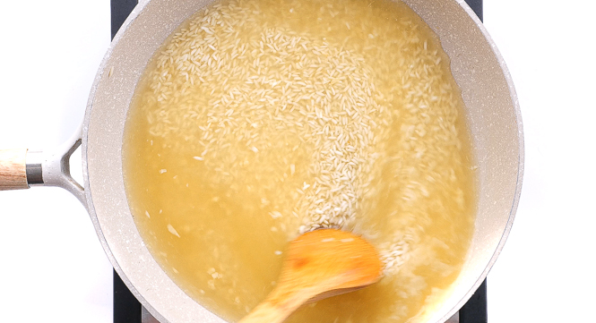 adding chicken broth to skillet