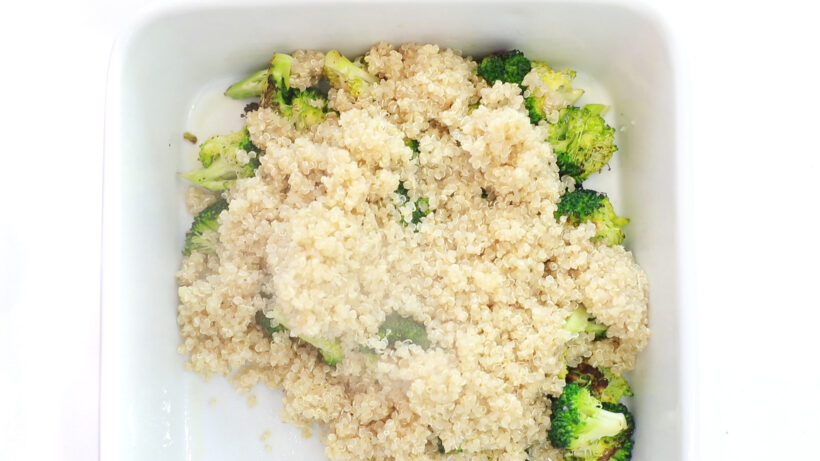 adding cooked quinoa and broccoli to white casserole dish