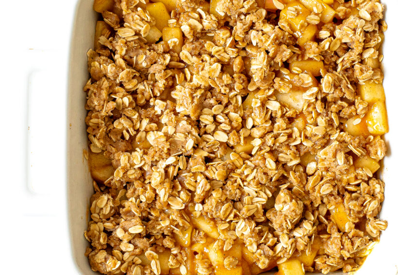 Baked healthier apple crumb bars in a white baking pan.