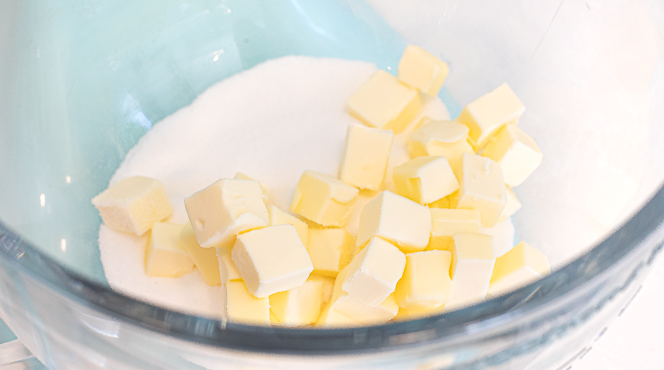 cubed softened butter and granulated sugar in a stand mixer with a clear glass bowl