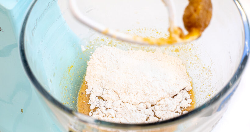 adding flour to stand mixer