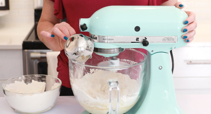 adding flour to stand mixer