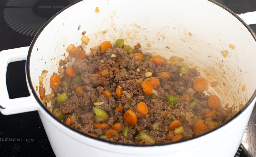 Browning ground beef in a large stock pot.