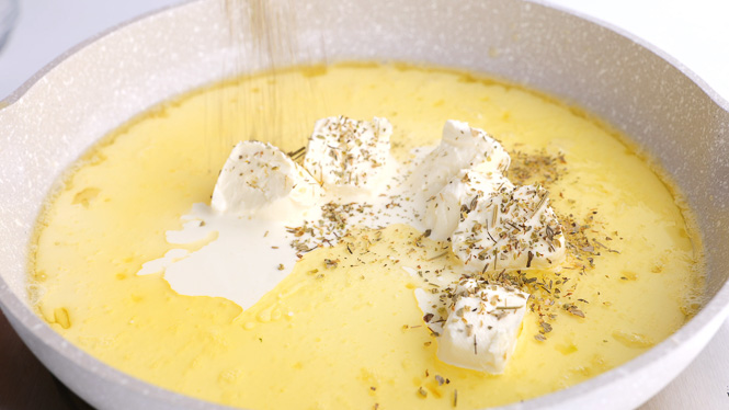 adding in cream cheese and herbs to skillet