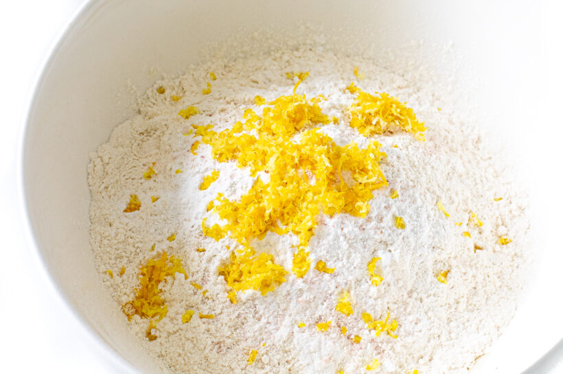 Flour and lemon zest in a bowl.
