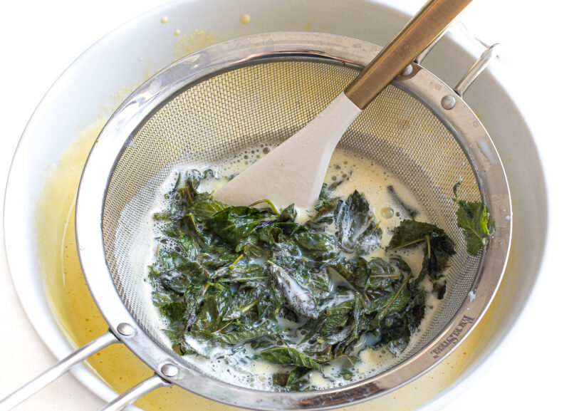 Straining the mint out of the milk mixture and into the egg mixture. 