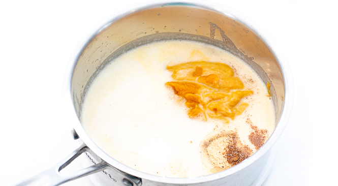 Mac and cheese sauce ingredients in a silver sauce pan.