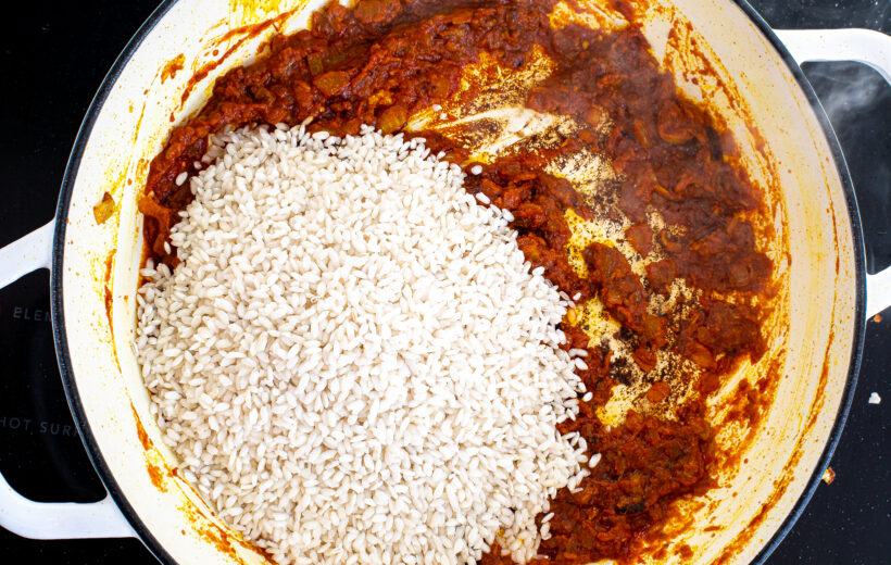 Onions, tomatoes, seasonings, and rice in a a large skillet.