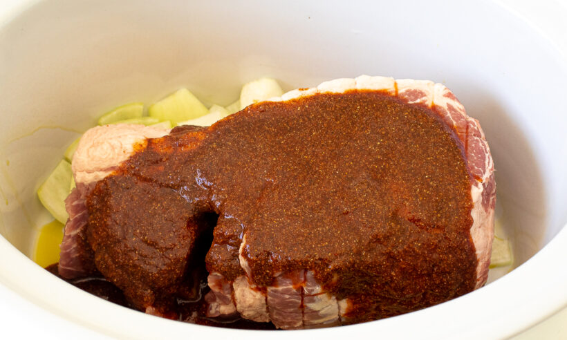 pouring spice mixture on top of roast