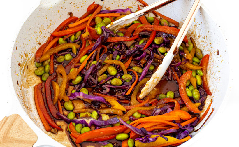 adding sauces to stir fried veggies