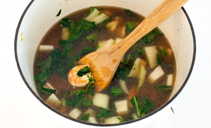 cooking shrimp and bok choy in broth