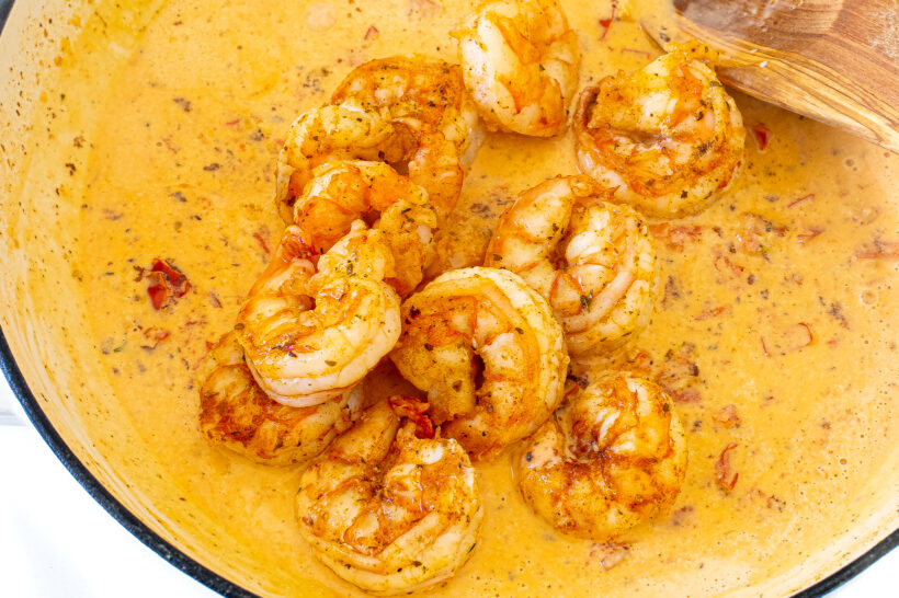 Shrimp tossed in a pan with the Cajun sauce.