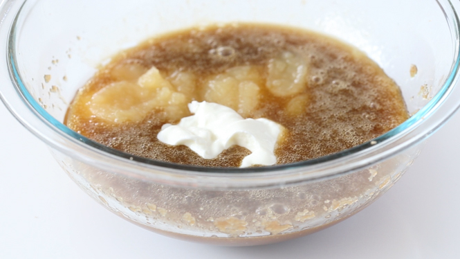adding wet ingredients to large clear bowl