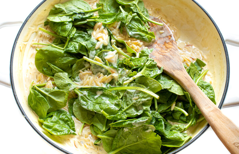 Spinach added to the creamy orzo.