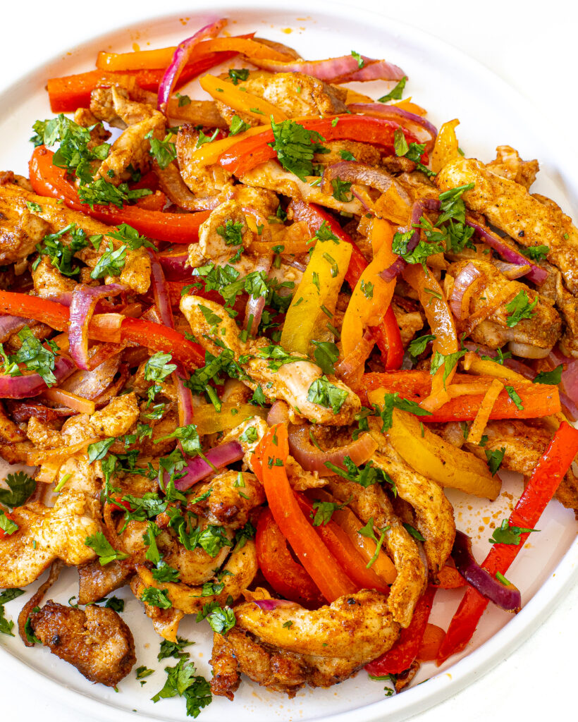 Cooked fajita ingredients on a white plate.