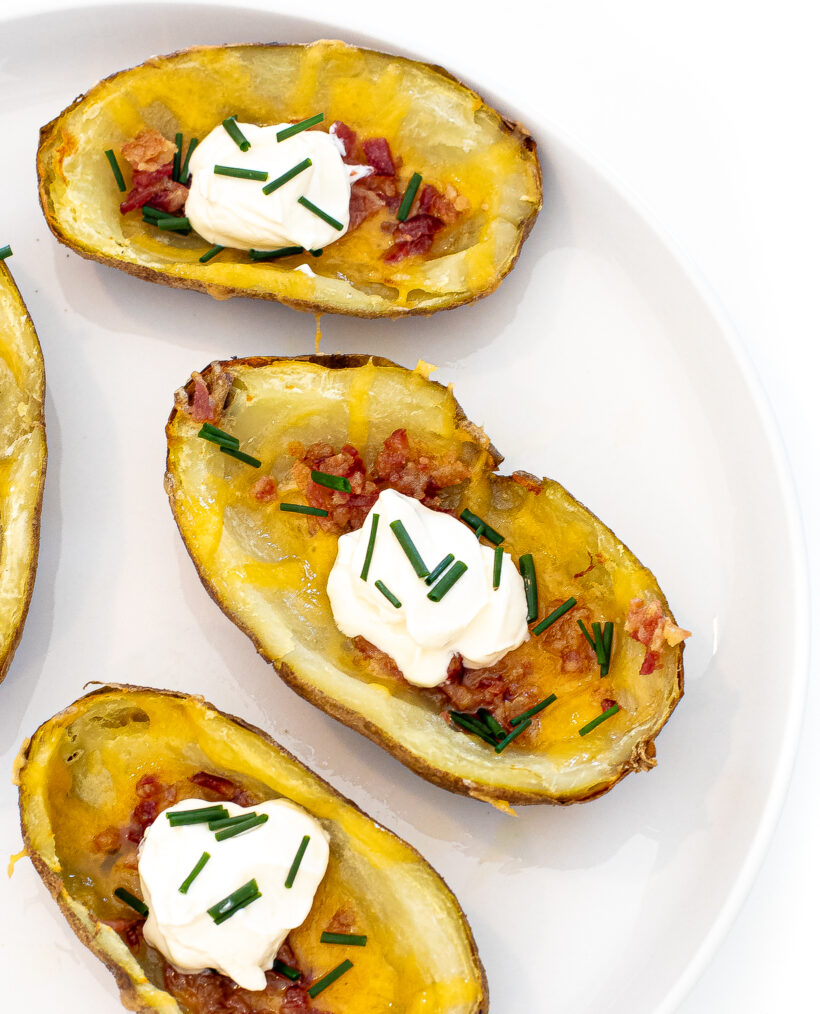 Potato skins set out on a white plate. 