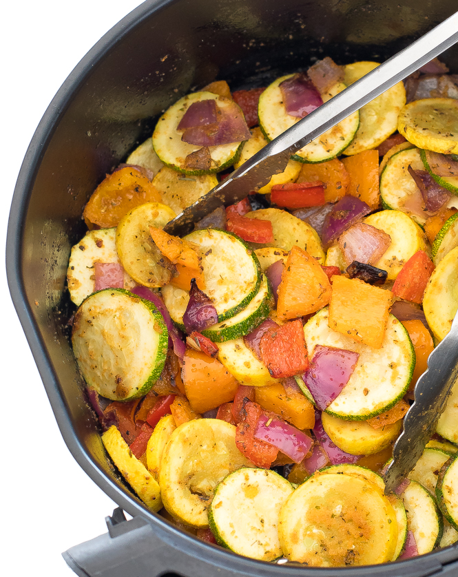 overhead shot of cooked vegetables in air fryer basket