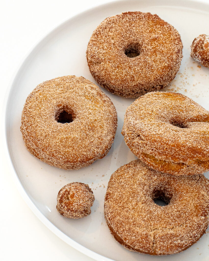 fried apple cider donuts on white plate