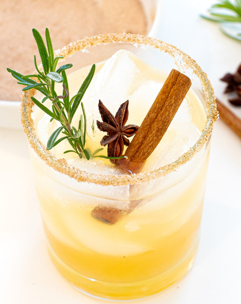 Apple cider margarita topped with rosemary, cinnamon stick and star anise.