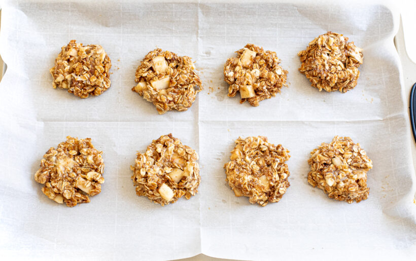 Apple cinnamon cookies on a baking sheet before being baked.