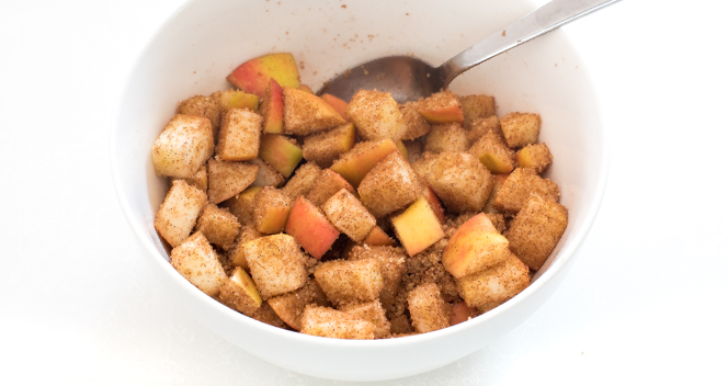 tossing cubed apples in cinnamon and sugar