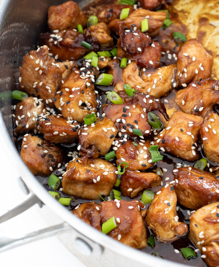 asian chicken bites topped with sesame seeds and green onions