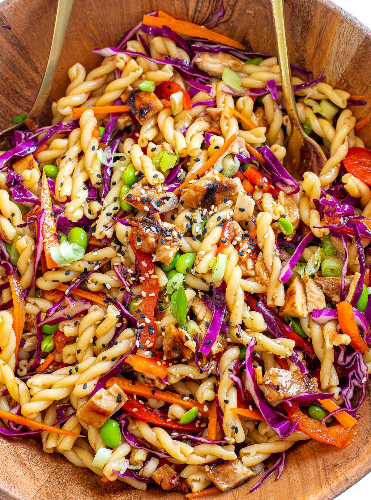 asian pasta salad in large wooden bowl