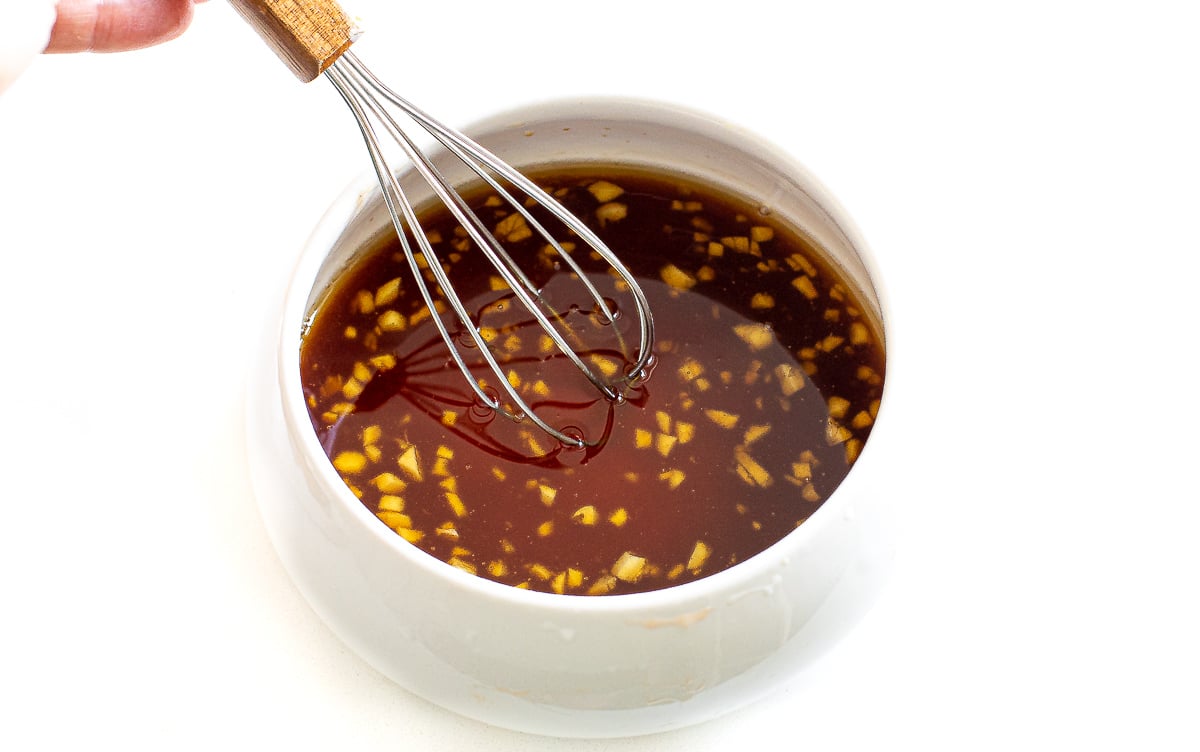 whisking asian dressing in bowl