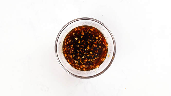mixing sticky Asian sauce in a clear bowl