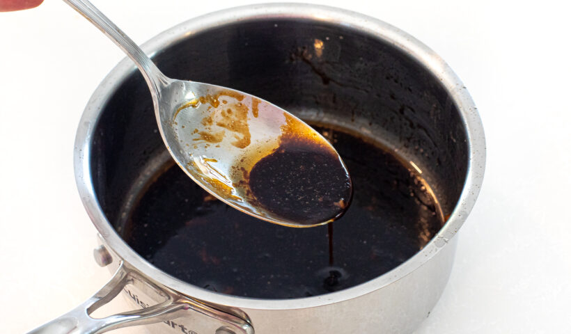 asian sauce in small pot with silver spoon
