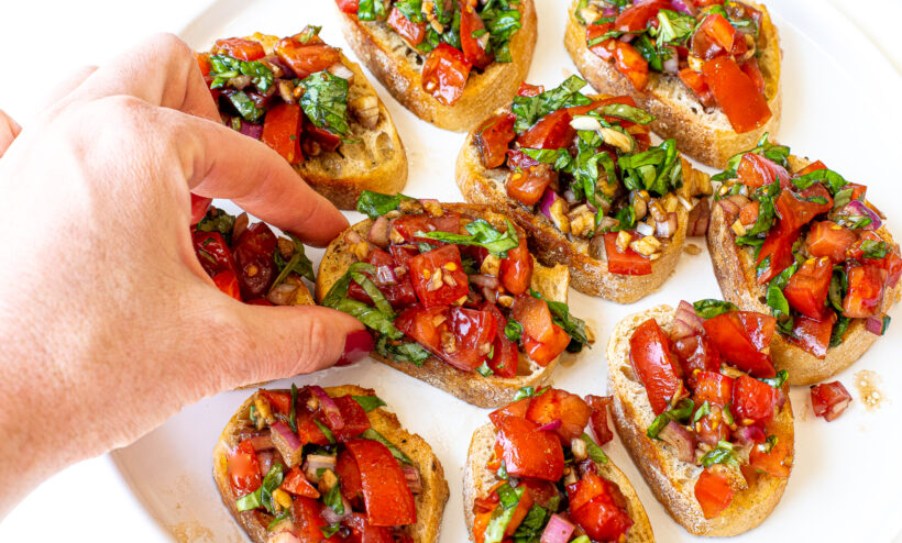 author grabbing bruschetta