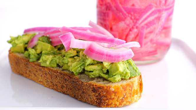 avocado toast topped with pickled red onions