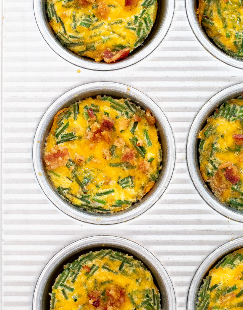 Bacon egg muffin cups in a silver muffin tin. 