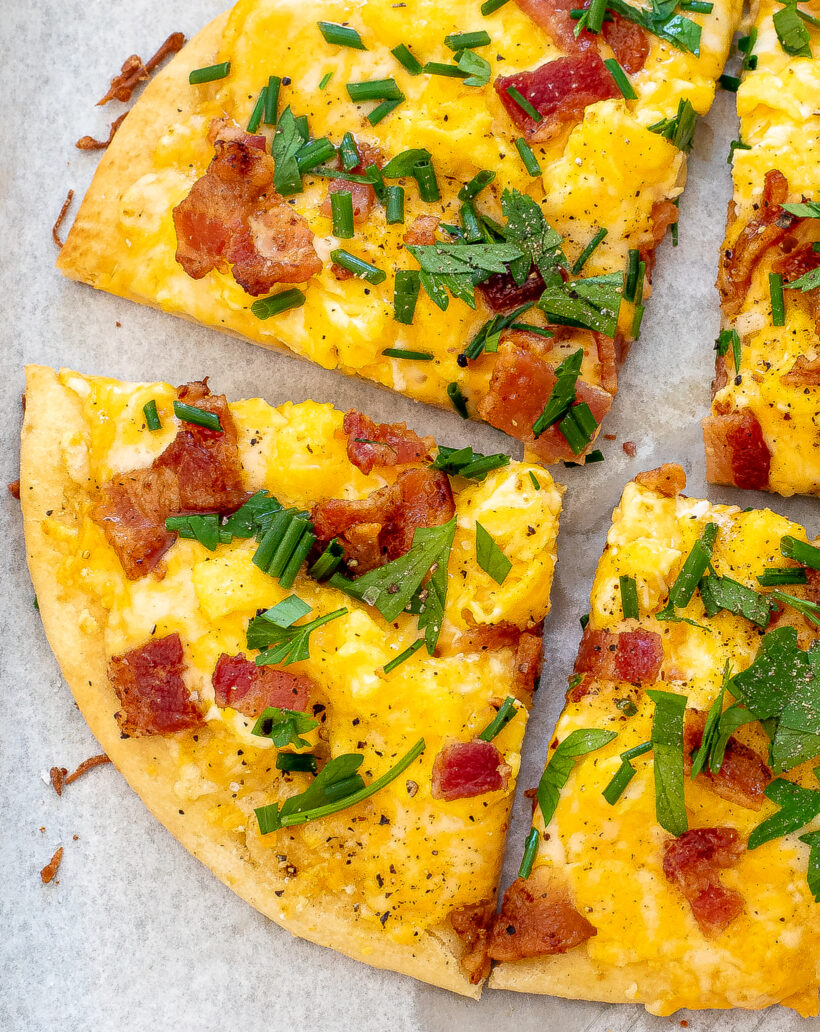 Up close shot of slices of breakfast pizza. 