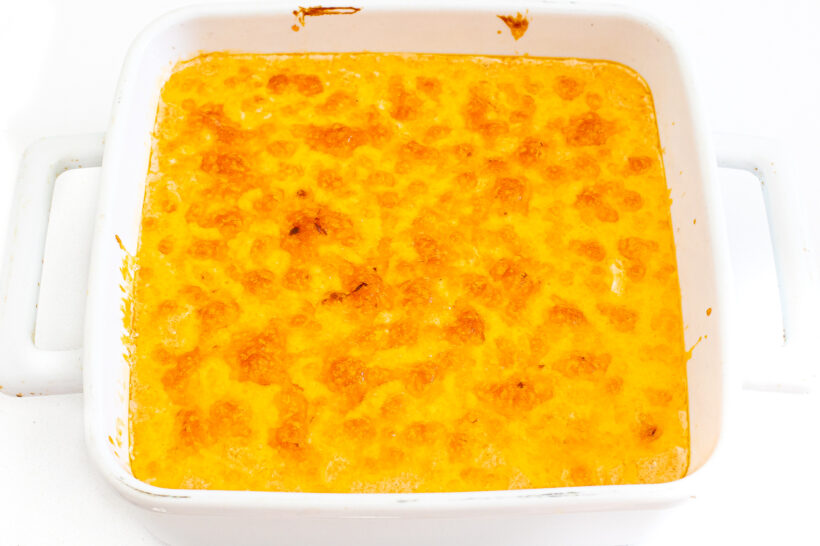 Buffalo chicken dip cooked and broiled in a baking dish.