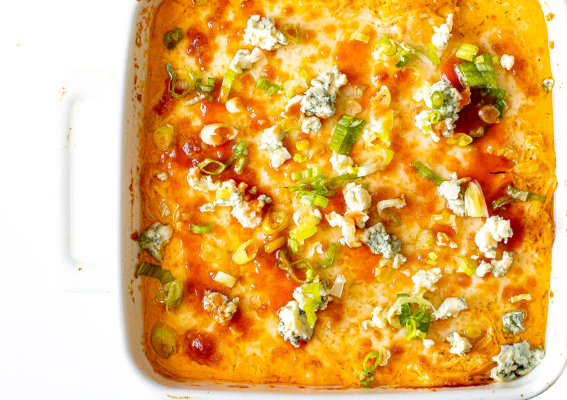Cottage cheese buffalo chicken dip in a white baking dish.