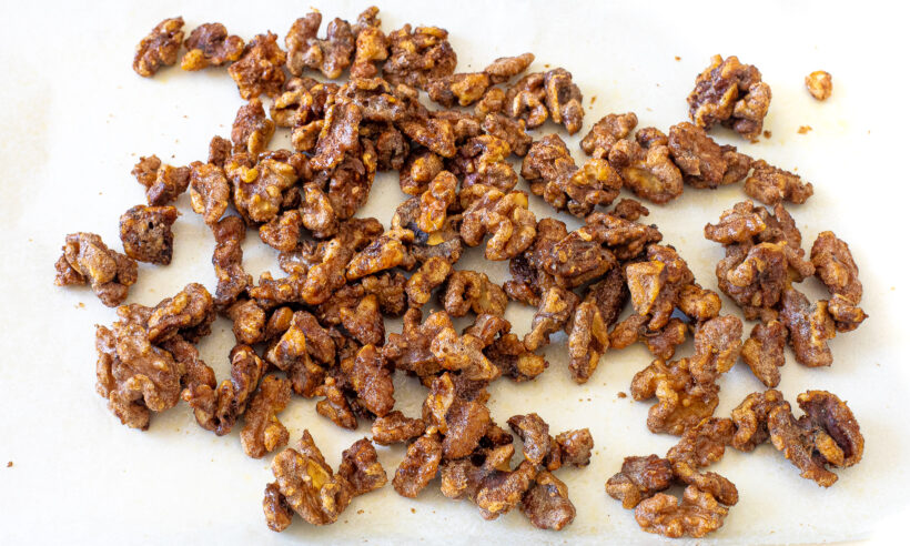 Baked candied walnuts on a baking sheet.