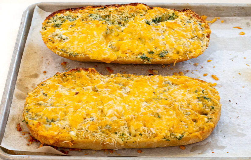 Cheezy garlic bread after it was baked on a baking sheet. 
