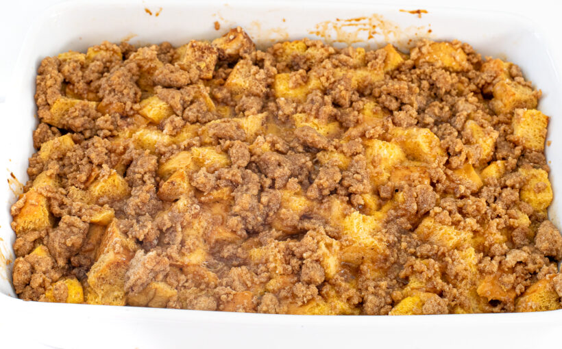 Golden and baked eggnog casserole in a white baking dish.