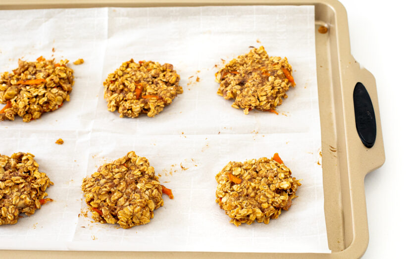 Baked carrot cake cookies on a baking sheet. 